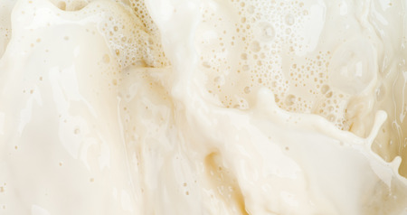 Soy milk splash motion and bubble foam on top view backgroundの写真素材