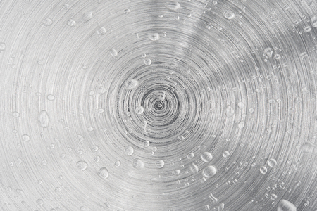 Water drop on metal aluminum circle texture surface background backdrop art abstract designの写真素材