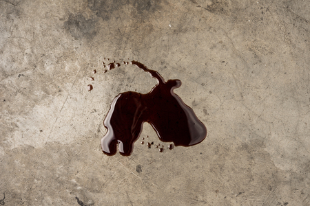 Old black oil motor car leak or drip on concrete floor on top viewの写真素材