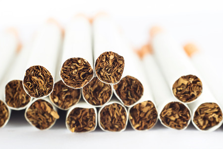 Heap of cigarettes on white backgroundの写真素材