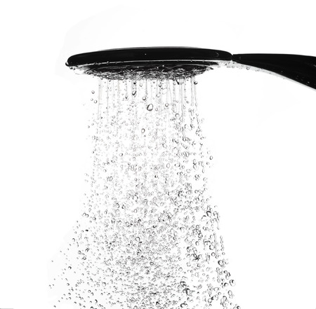 Water drops from shower head in bathroom on white backgroundの写真素材