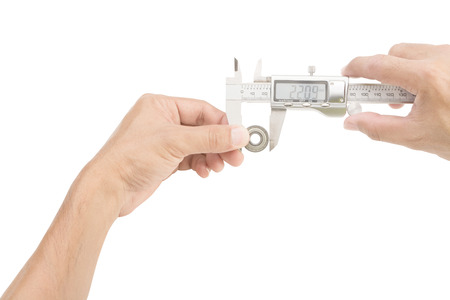 Hands holding Vernier caliper and measuring bearing on white backgroundwith clipping pathの写真素材