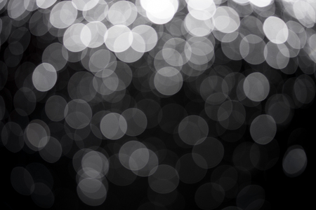 Bokeh on dark black backgroundの写真素材