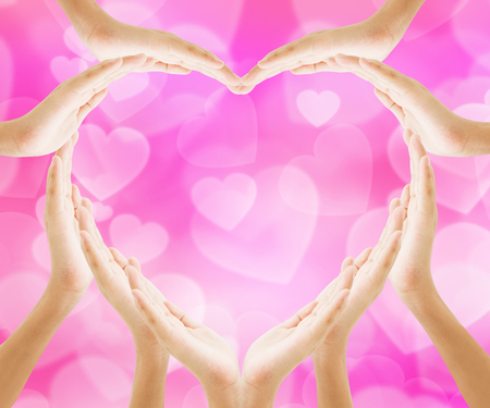 Hands heart shape with pink bokeh heart background , love concept holiday valentine's dayの写真素材