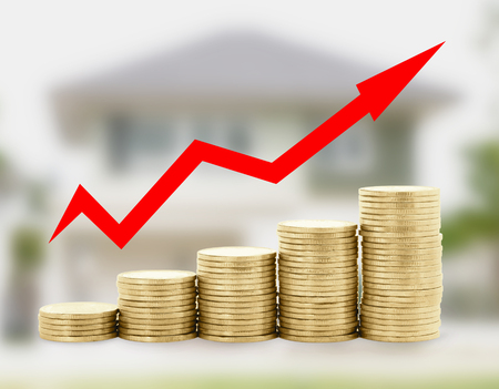 Gold coin diagram with arrow on home blur background , success financial conceptの写真素材