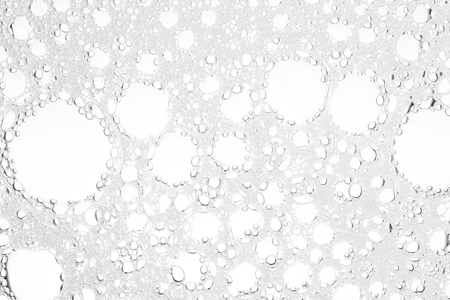 Foam bubble from soap or shampoo washing on top viewの写真素材
