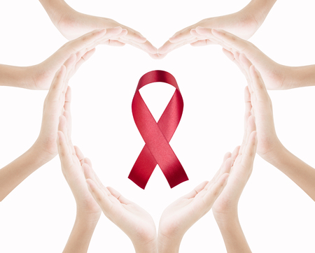 Hands female heart shape with red ribbon isolated on white background , love care world aids day conceptの写真素材