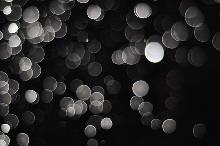 Bokeh from water drop defocus on black dark backgroundの写真素材