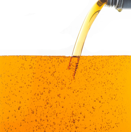 Pouring motor oil on white backgroundの写真素材