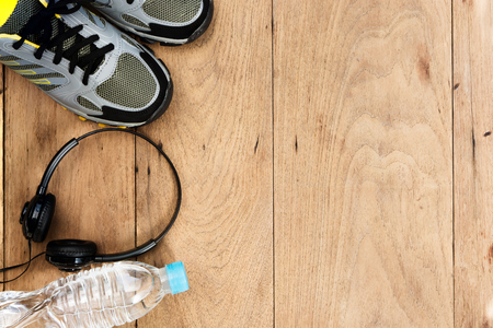 Sport shoes,sneaker and bottle of water on wooden background ,sport equipment top viewの写真素材
