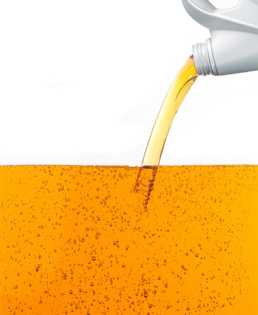 Pouring motor oil on white backgroundの写真素材