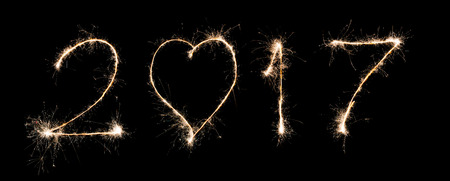 Text font 2017 firework written with Sparkle on black background sign calendar of happy new year の写真素材