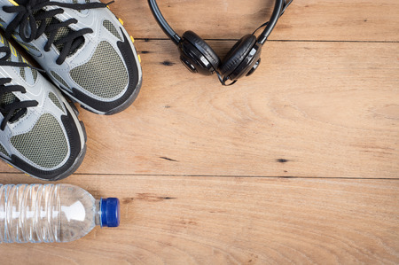 Sport shoes,sneaker and bottle of water on wooden background ,sport equipment top viewの写真素材
