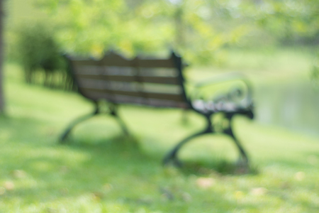 Chair in park green bokeh blurred backgroundの写真素材