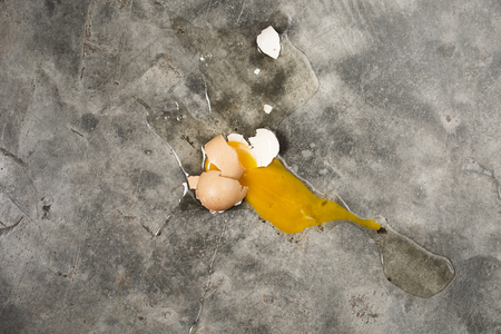 Egg fall and broken on concrete floor , top viewの写真素材