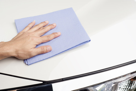 Hand of man wipe and cleaning  surface white car and wax after washingの写真素材