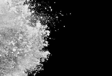 White powder or flour explosion isolated on black background  freeze stop motion object designの写真素材
