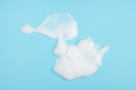 Foam bubble drop on blue background on top view hi resolution photo object designの写真素材