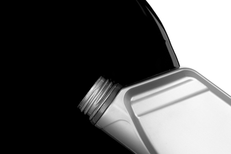 Old black oil lubrication of car or motorcycle spill from bottle isolated on white background photo object designの写真素材