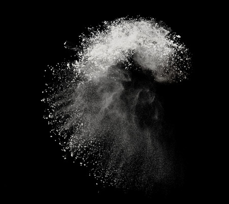 White powder or flour explosion isolated on black background  freeze stop motion object designの写真素材