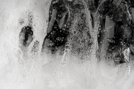 Motion of bubble foam transparent on black backgroundの写真素材