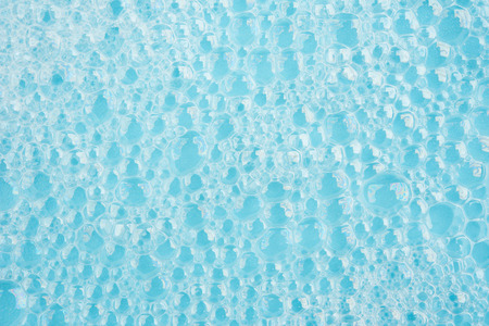 Bubble foam on water surface blue background