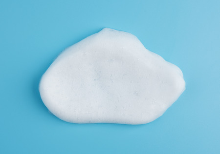 Foam bubble on blue background on top view object beatuy health care concept designの写真素材