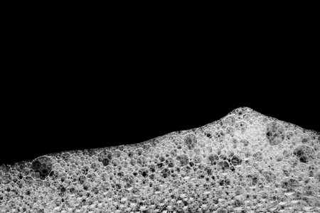 Soap foam Shaving cream bubble isolated on black background top view object health conceptの写真素材