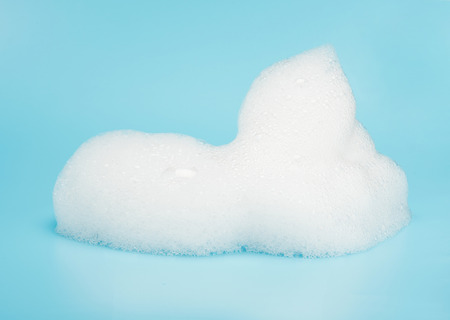 Soap foam bubble isolated on blue background object beatuy health care conceptの写真素材