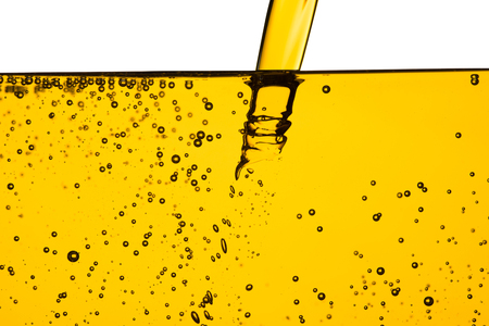 Oil car motor or vegetable oil pouring with bubble isolated on white backgroundの写真素材