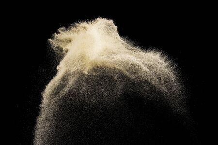 Sand flying explosion isolated on black background ,throwing freeze stop motion object designの写真素材
