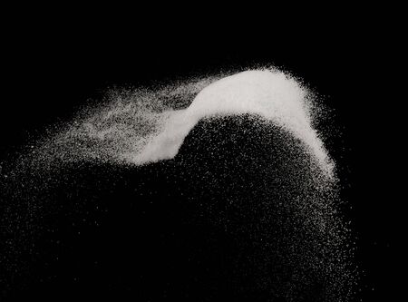 Fine salt or fine sugar splash explosion on black background ,stop motion food object designの写真素材