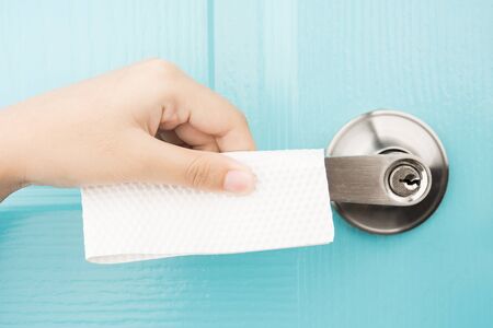 Hand tissue paper protect virus bacteria coronavirus covid-19 from door knob health care hygiene conceptの写真素材