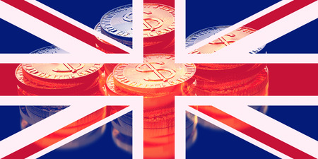 pile of gold coins with flag of the great britain (uk) ,3D illustration concept designの写真素材