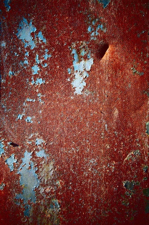 Red color of a rust with a shabby colourful coveringの写真素材