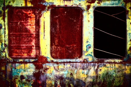 Three old windows closed by different barriersの写真素材