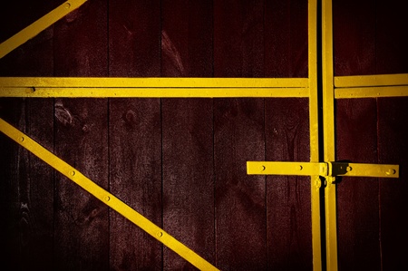 Wooden brown gate, with an yellow iron frameの写真素材