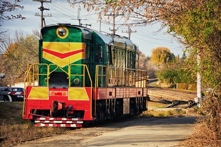 It is green a red diesel train on the railwayの写真素材
