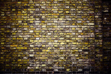 Background in style grunge. Old ragged wall with an unusual stone layingの写真素材