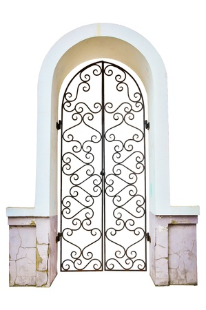 Facade an arch with the closed curly metal door. isolatedの写真素材