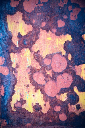 Old rusty surface with pieces of an exfoliating paintの写真素材