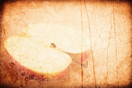 Art grunge a background. The cut off piece of an apple on an old wall of beige colorの写真素材