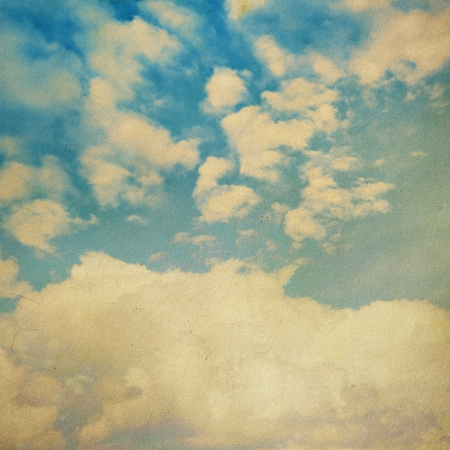 clouds on a textured vintage paper background, with grunge stainsの写真素材