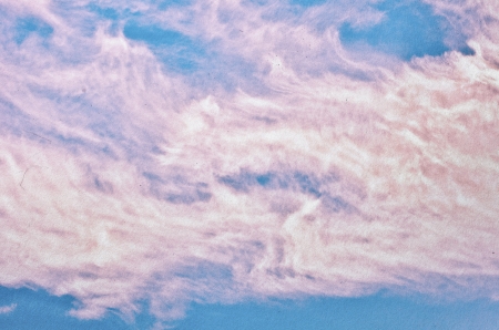 clouds on a textured vintage paper background, with grunge stainsの写真素材