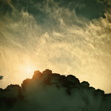 clouds on a textured vintage paper background, with grunge stainsの写真素材