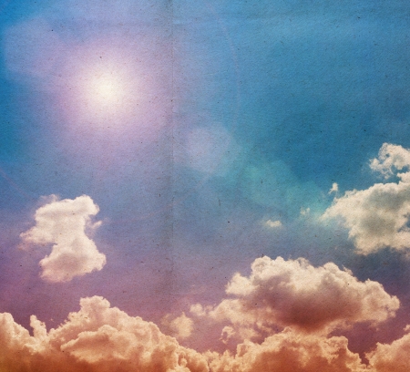 clouds on a textured vintage paper background, with grunge stainsの写真素材
