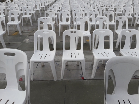 Row of white plastic chairs.の写真素材