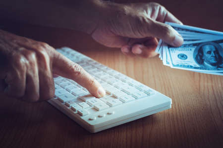Cheat business man enter on keyboard for money. concept corruptionの写真素材