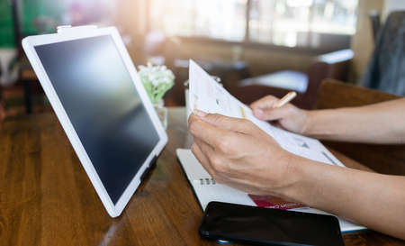 Focus on male hand reading contract on credit card statementの写真素材