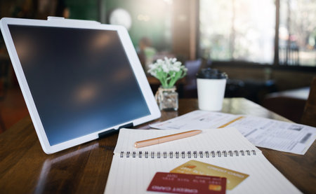 Focus of pen on book with two credit card and digital tablet on deskの写真素材